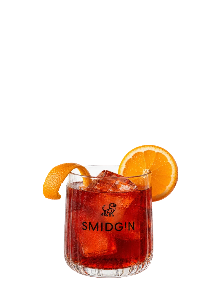 Negroni, a deep red drink in a cut-glass tumbler with an orange slice and a twist of peel